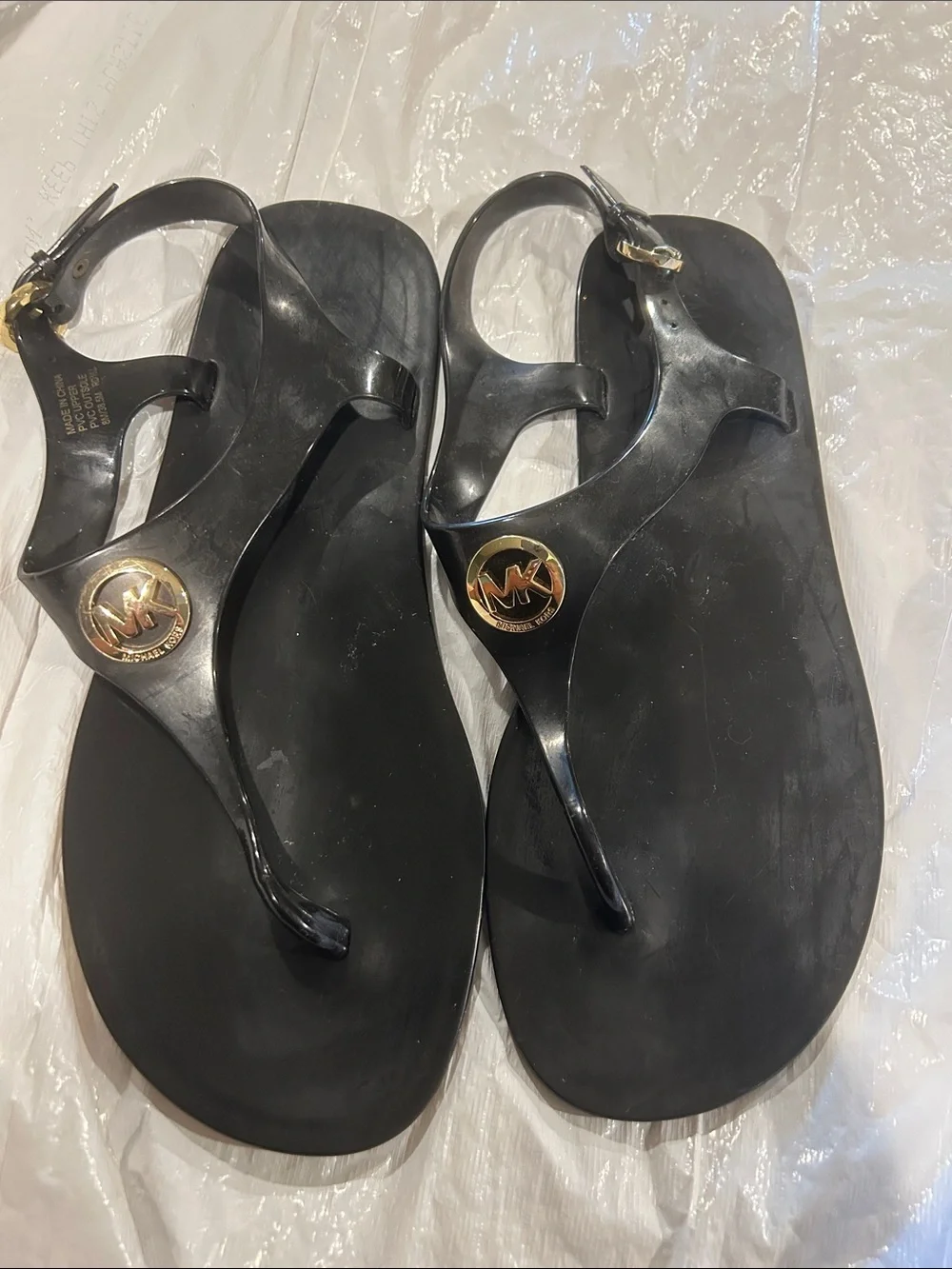 Michael Kors Black Jelly Logo Thong Sandals with Gold MK Medallion